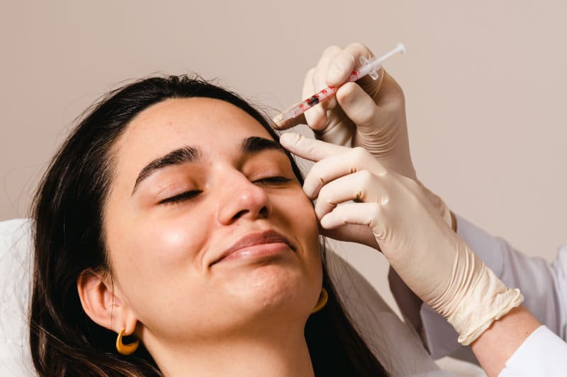 doctor applying botox to a female patient